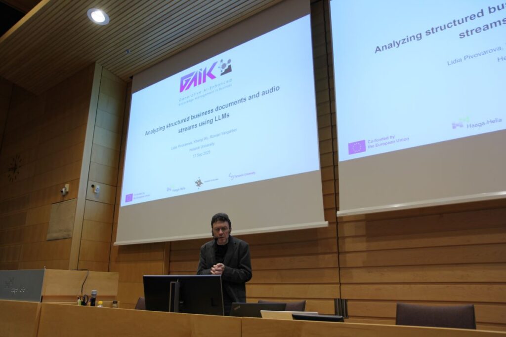 A man standing in the audiotorium in front of the presentation