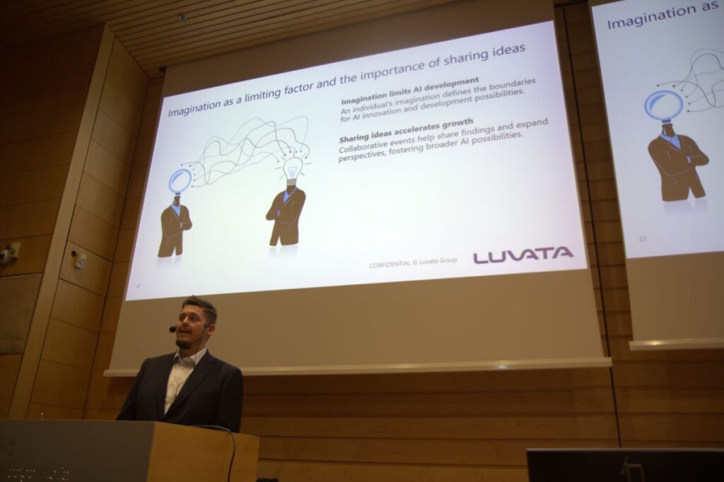 A man standing in the audiotorium in front of the presentation